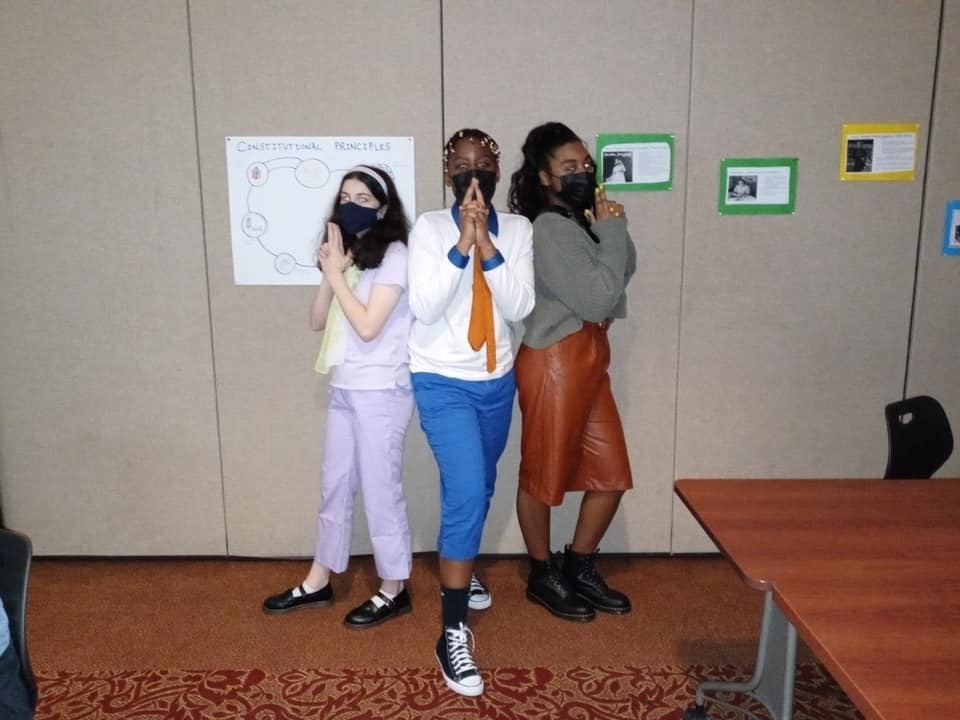 Students pose in Charlie's Angels style while wearing Scooby Doo character outfits