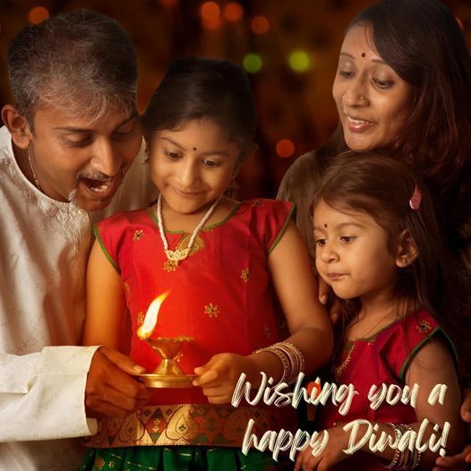 Family holding a candle with text "Wishing you a happy Diwali!"